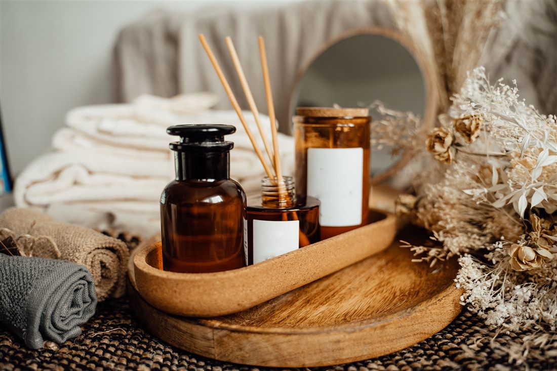Productos y ambiente cálido del spa: toallas, aceites y velas